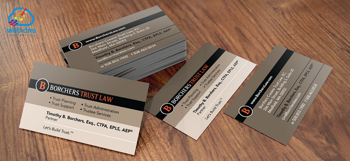 Business cards designed for Borchers Trust Law firm by Web DNA displayed on conference room table.